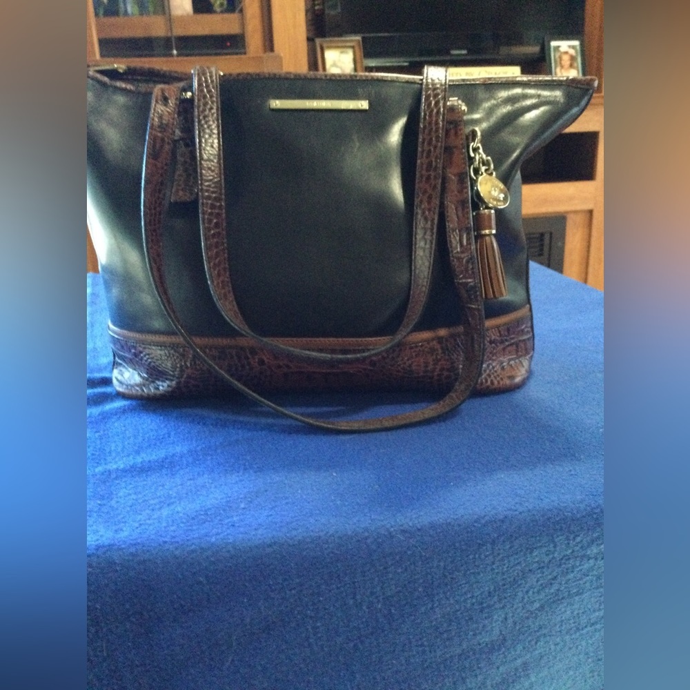 Brahmin shoulder bag with brown trim as shown. Feet on bottom. Good condition.